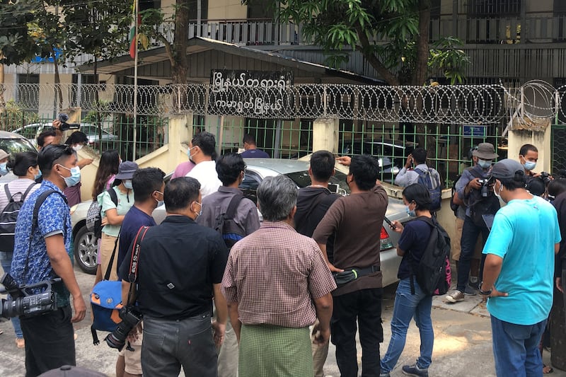 Members of the media gather outside Kamaryut Court in Yangon during a hearing in the case of Associated Press photographer Thein Zaw, who was arrested as he covered a demonstration against the military coup, March 12, 2021. AFP