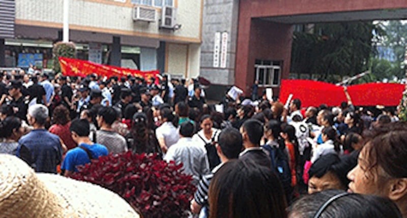 四川雙流縣約四百名業主抗議購買房屋5年,開發商仍未給予產權,週三到縣政府外拉起橫額抗議。(中國天網提供)