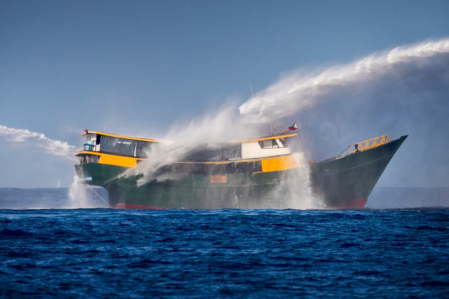 A Chinese Coast Guard ship fires a water cannon at Unaizah May 4, a Philippine Navy chartered vessel, conducting a routine resupply mission to troops stationed at Second Thomas Shoal, on March 5, 2024 in the South China Sea.