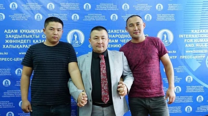 别克扎提.马克苏提汗(中)与志愿者合影。(志愿者提供/记者乔龙)