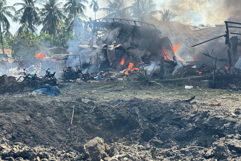 A fire continues to burn following a military airstrike on a market and adjacent bridge in Kyauktaw, Western Rakhine state, Myanmar, Sept. 28, 2026.