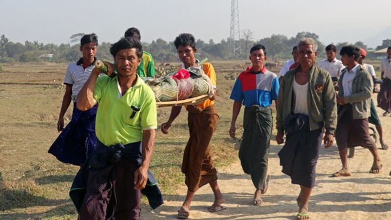 Myanmar residents carry the body of an ethnic Rakhine woman for burial in Rathedaung township after fresh fighting between the Myanmar military and the Arakan Army in western Myanmar's Rakhine state, Feb. 21, 2019.