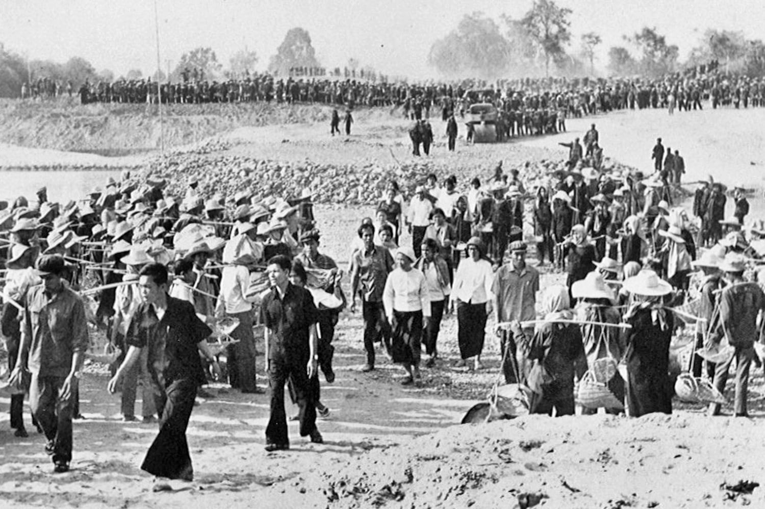 Workers at a Khmer Rouge labor camp carry dirt to build a dam in this undated photo.
