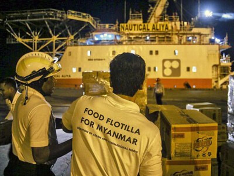 Volunteers unload boxes of humanitarian aid from Malaysia intended for Rohingya Muslims at Thilawa port terminal in Yangon, Feb. 9, 2017.