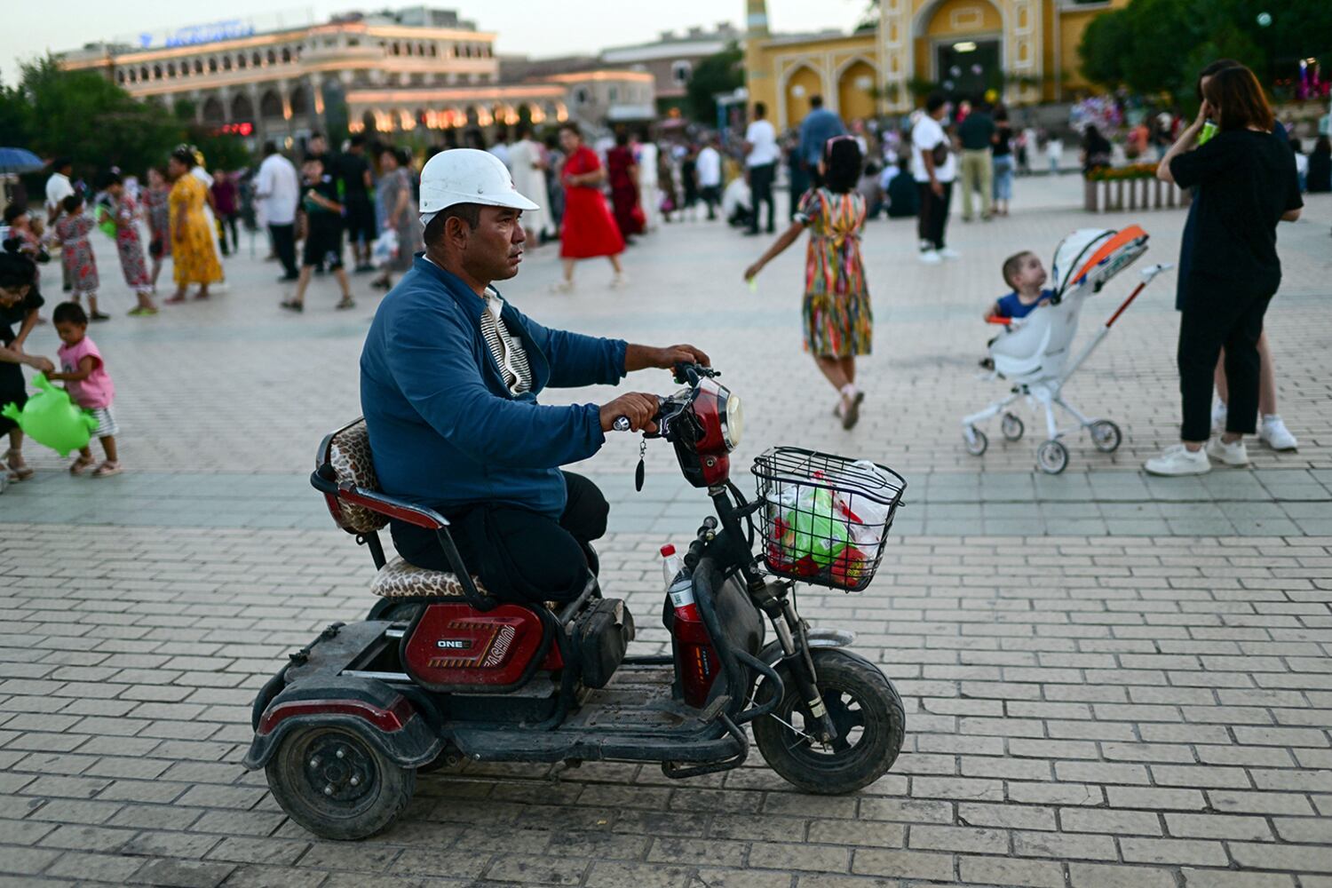 Uyghurs populate the area outside the Id Kah Mosque in Kashgar city in northwestern China's Xinjiang region, July 13, 2023.