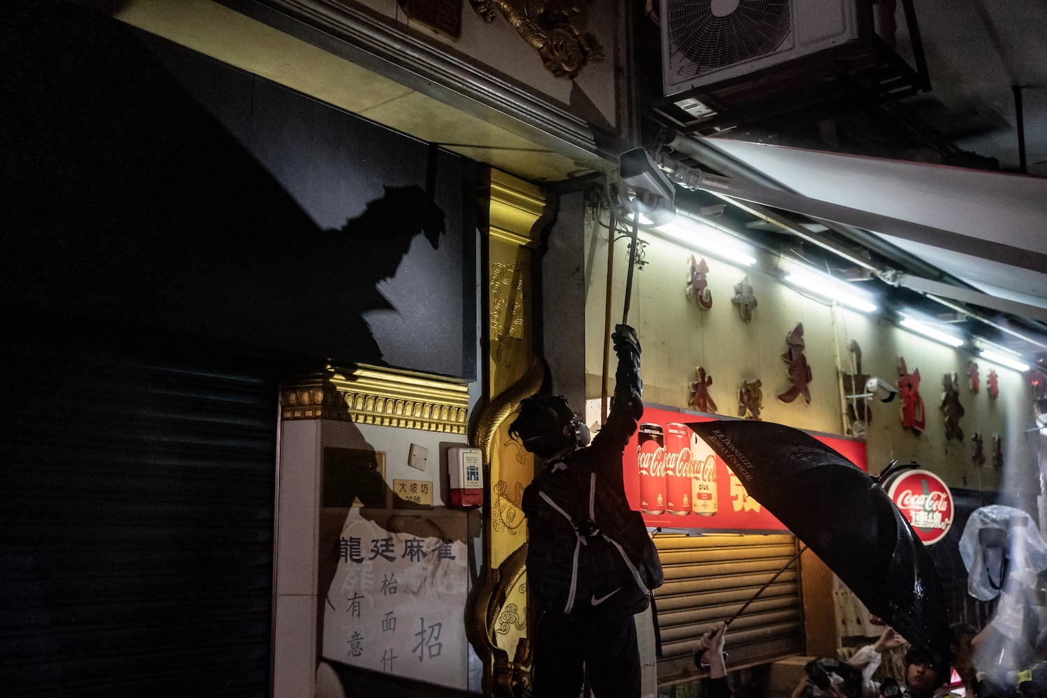 A protester attempts to break a surveillance camera in Tsuen Wan district on August 25, 2019 in Hong Kong.