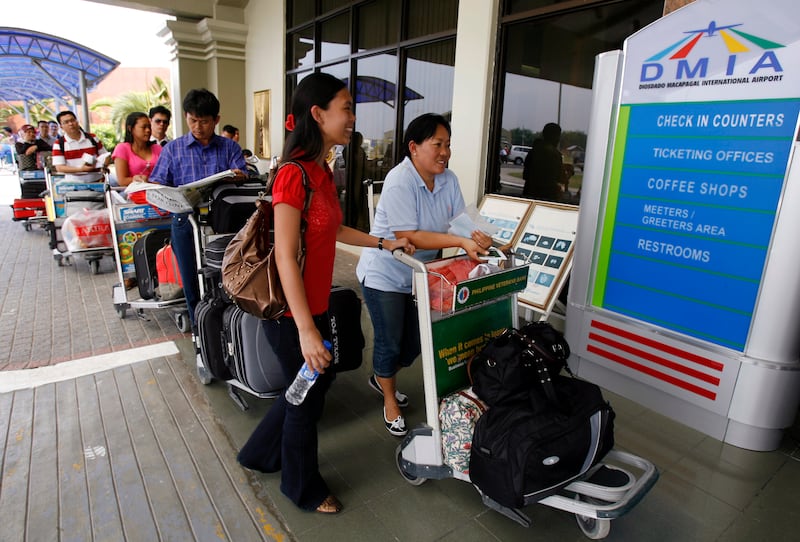 Passengers queue to enter the Diosdado Macapagal International airport, formerly Clark Air Base in Pampanga province north of Manila, March 26, 2008. Other parts of the former U.S. Air Base and the associated military reserve are today part of New Clark City, a planned community that will feature a new technology hub.