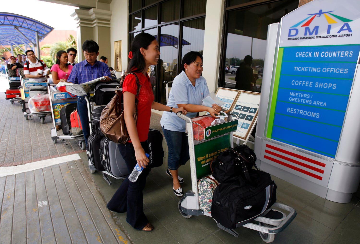 Passengers queue to enter the Diosdado Macapagal International airport, formerly Clark Air Base in Pampanga province north of Manila, March 26, 2008. Other parts of the former U.S. Air Base and the associated military reserve are today part of New Clark City, a planned community that will feature a new technology hub.