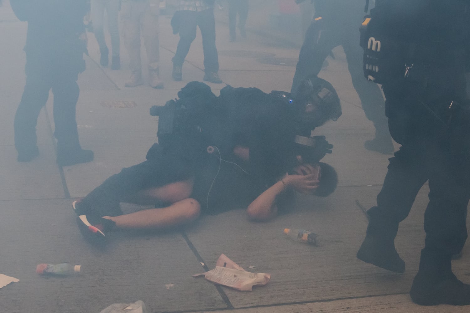 A demonstrator is arrested by riot police in a cloud of tear gas during a protest in Tsim Sha Tsui district on October 20, 2019 in Hong Kong.