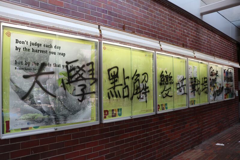 Graffiti with Chinese words “Why have universities become battlegrounds?” is seen at he Hong Kong Polytechnic University (PolyU) campus that has been on lockdown for a week in Hong Kong