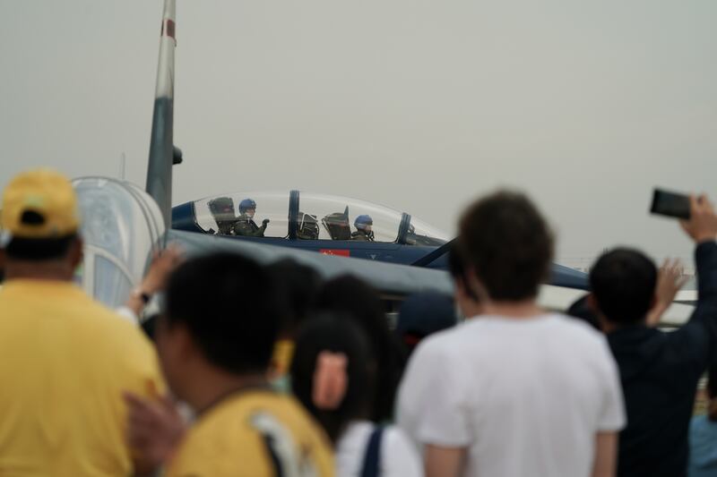 Chinese People’s Liberation Army Air Force pilots greet spectators at Don Mueang airbase in Bangkok, March 7, 2025.