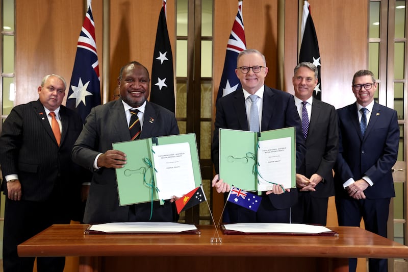 Australia's Prime Minister Anthony Albanese and Papua New Guinea's Prime Minister James Marape and other officials after the signing of the Pukpuk treaty at Parliament House in Canberra on October 6, 2025.
