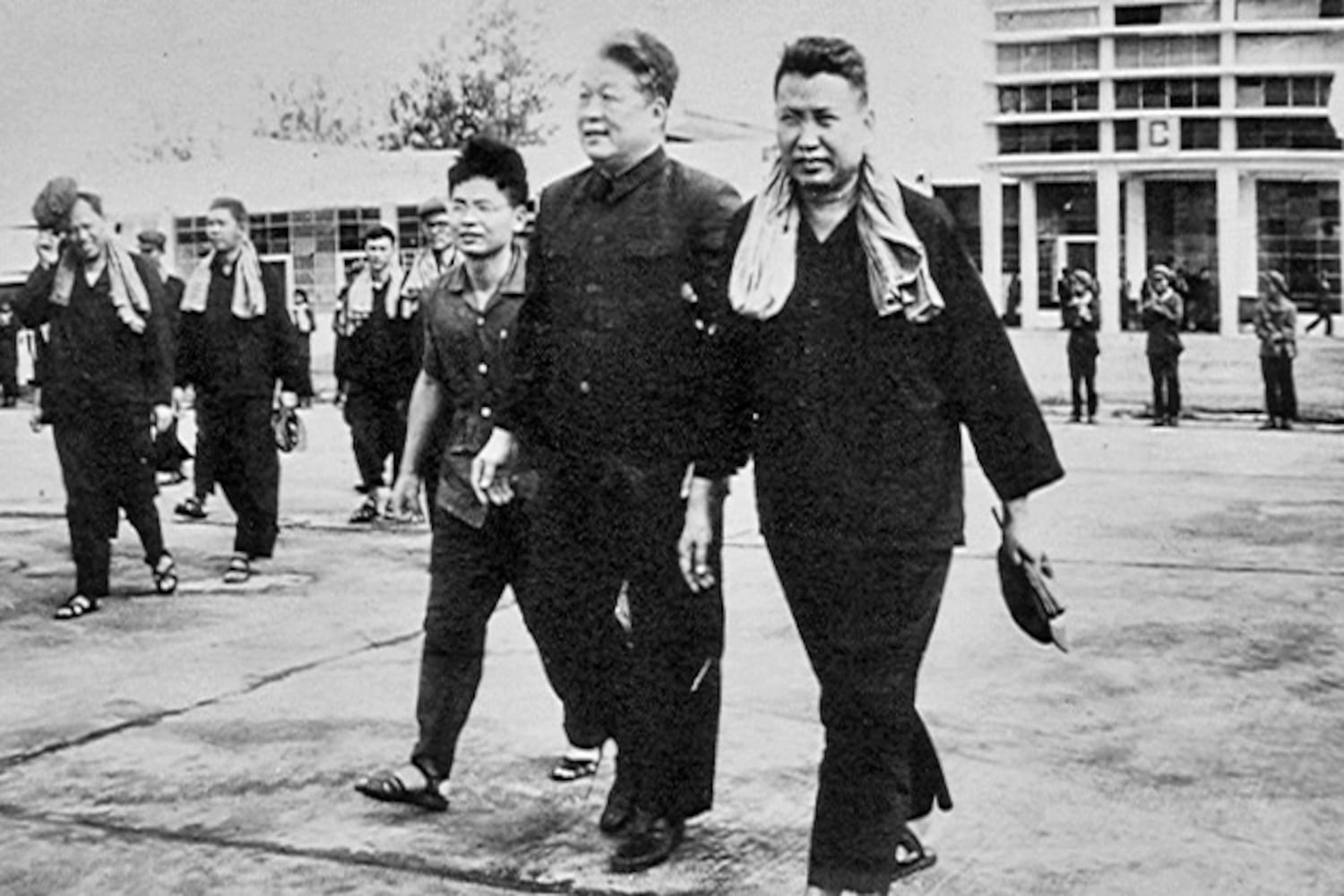 Pol Pot, right, walks with Chinese Ambassador Sun Hao, center, and Foreign Minister leng Sary, far left, in Phnom Penh, in 1975.
