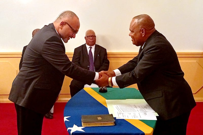Solomon Islands' new prime minister Matthew Wale (left) is sworn in by Governor-General David Kapu at the Government House in Honiara, Solomon Islands, May 15, 2026.