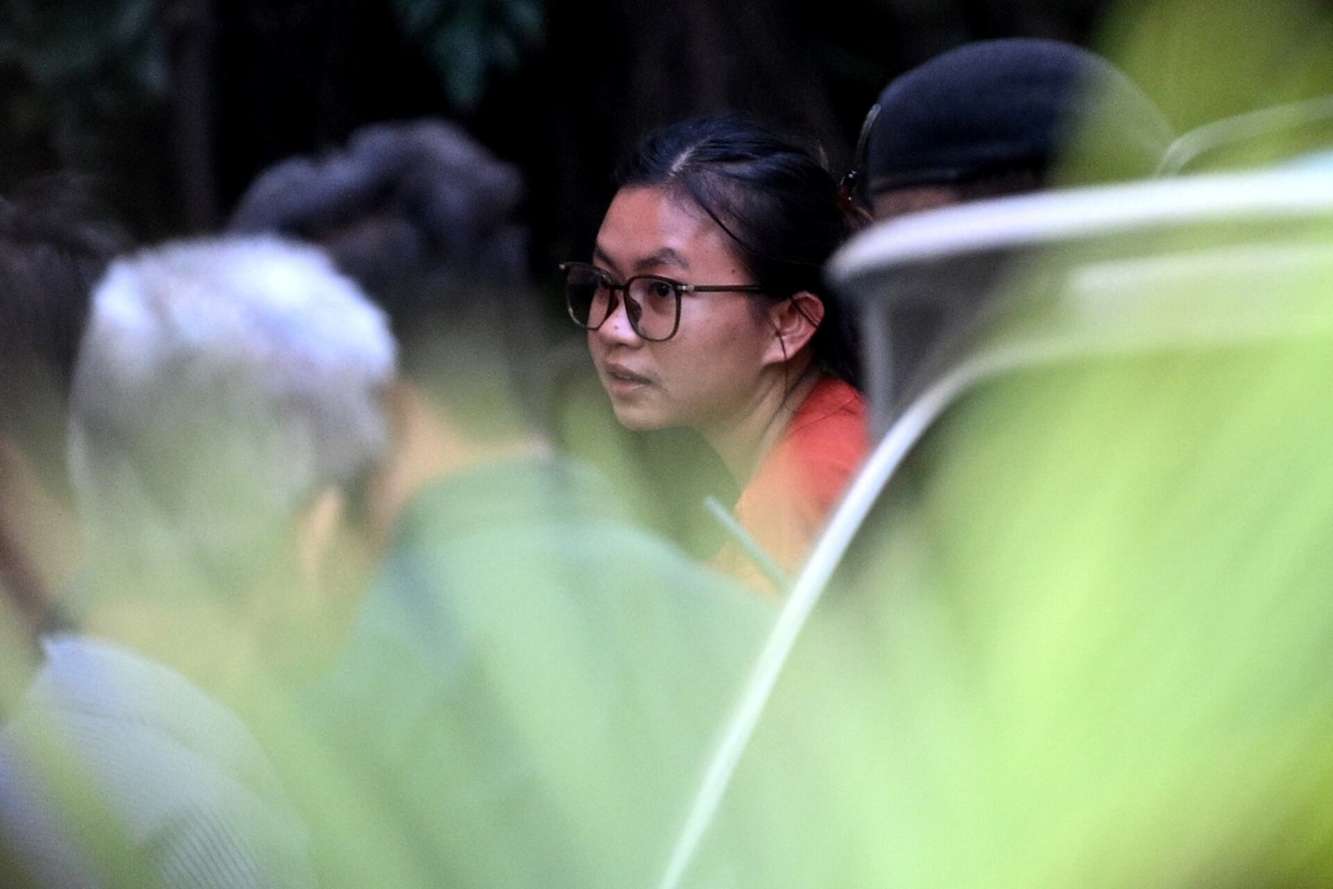 Phuon Keoraksmey (C) is escorted by police officials outside the Supreme Court in Phnom Penh on April 30, 2025.