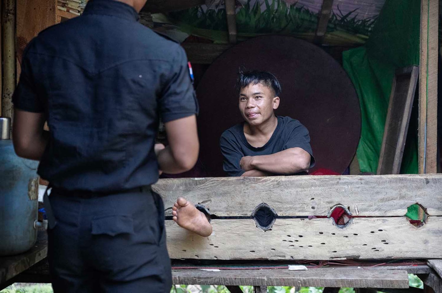 Officer “Sunday” is locked in a British colonial-era restraint at KSP Station 8 after reporting back to work a week late following his vacation, in southern Shan state, Myanmar, Nov. 4, 2024.