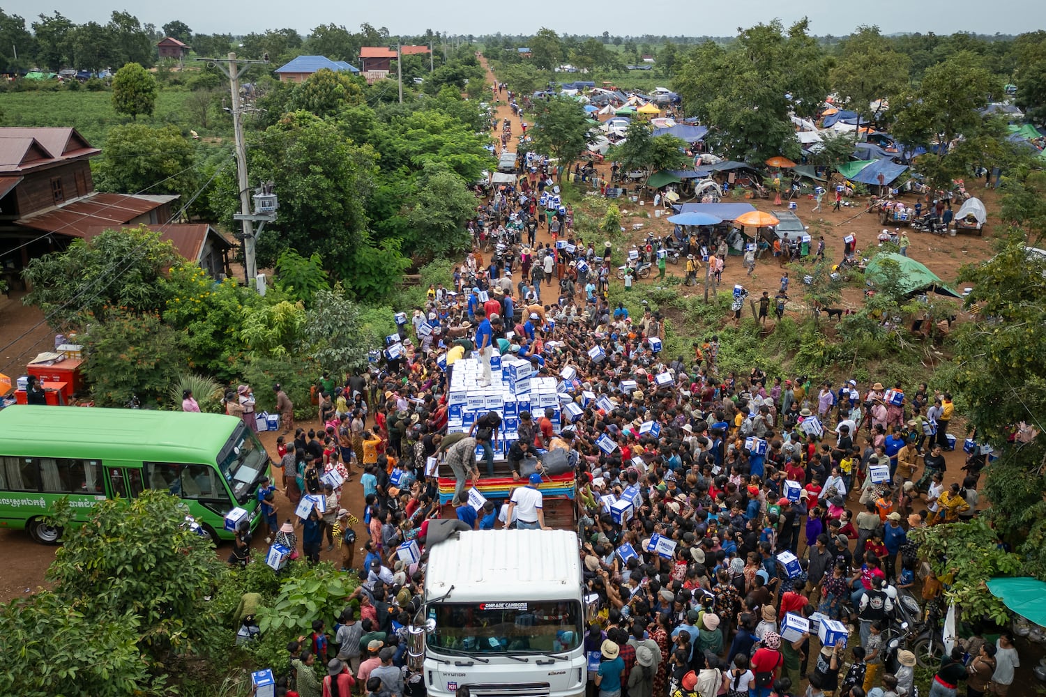 Displaced Cambodians receive water at the Battkhao Resettlement Camp in Oddar Meanchey province, Cambodia, July 26, 2025.