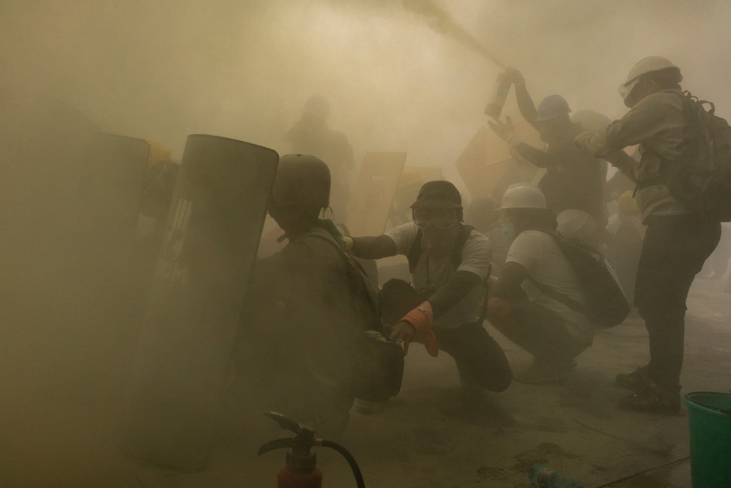 Protesters defend themselves with makeshift shields during clashes with riot police on February 28, 2021 in Yangon, Myanmar. Myanmar's military government has intensified a crackdown on protesters in recent days, using tear gas, charging at and arresting protesters and journalists.