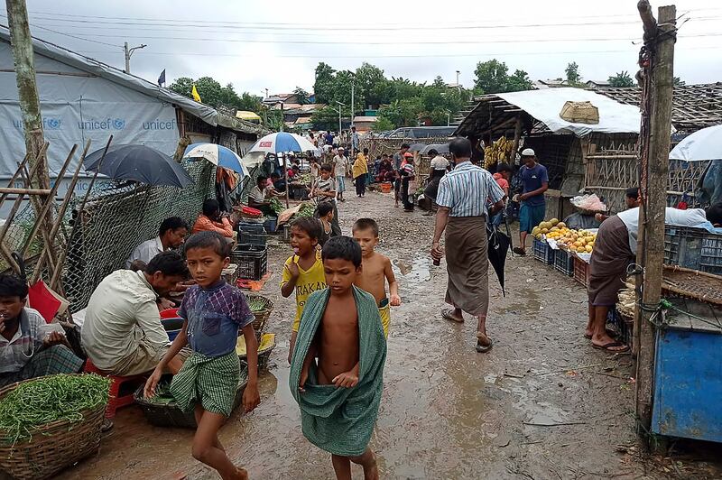 Rohingya refugees walk along a path at Kutupalong refugee camp in Ukhia, Bangladesh, Aug. 25, 2021. Credit: AFP