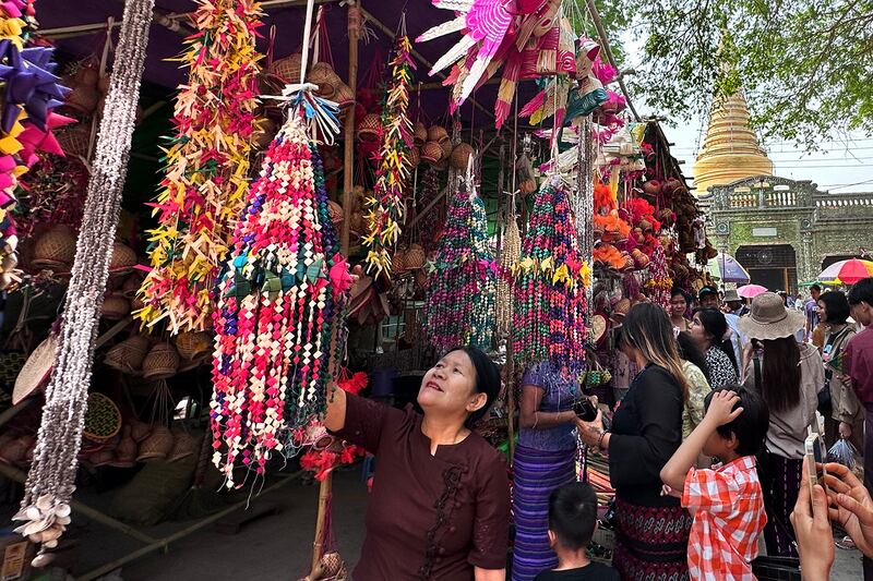 Visitors browse at the annual Shwe Saryan Pagoda harvest festival in Shwe Saryan village, Patheingyi township, Mandalay region, Myanmar, March 11, 2025.