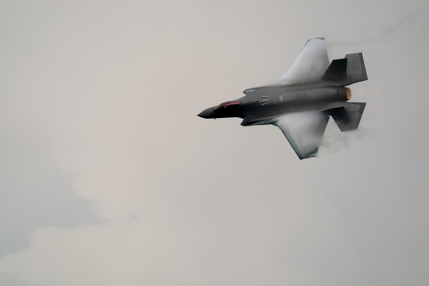 Vortices are visible on its wings as a U.S. Air Force F-35A demonstration team fifth generation jet performs over Don Mueang air base in Bangkok, March 7, 2025.