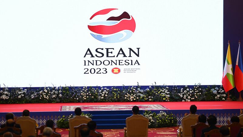 Hun Sen, left, hands over the gavel to Indonesian President Joko Widodo during a transfer of ASEAN Chairmanship during the closing ceremonies of the 40th and 41st ASEAN Summit in Phnom Penh, Cambodia, Sunday, Nov. 13, 2022 by AFP-7.jpg