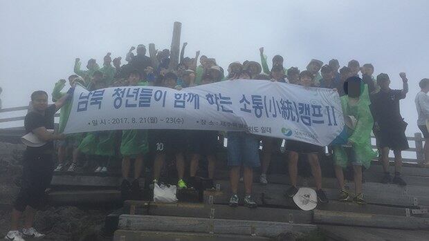 '남북청년 소통캠프'에 참가한 남북 대학생과 해군 장병이 함께 오른 한라산 정상, 백록담에서. 