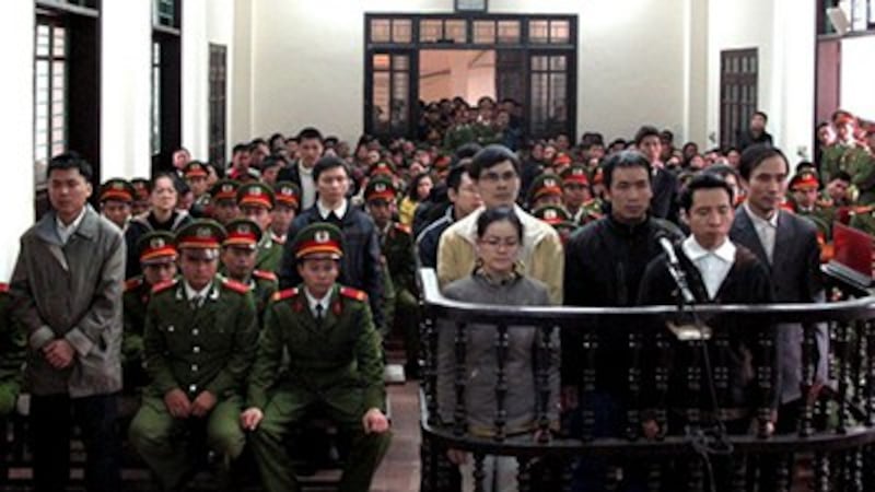 Activists convicted of plotting to 'overthrow' the government listen to their verdicts at a court in Vinh, Nghe An province on Jan. 9, 2013.