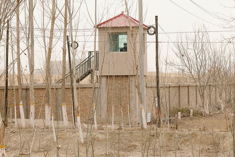 A security guard watches from a tower at a detention facility in Yarkent county in China's Xinjiang region on March 21, 2021.