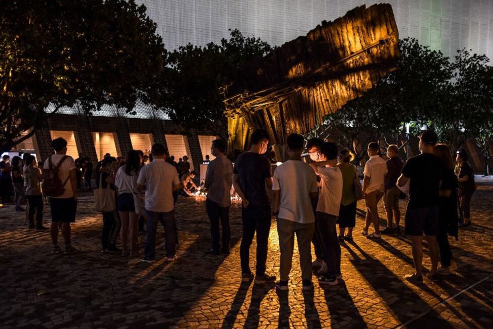 People attend a candlelight vigil along the Tsim Sha Tsui waterfront in Hong Kong to mark the 31st anniversary of the 1989 Tiananmen Square crackdown in Beijing, June 4, 2020.