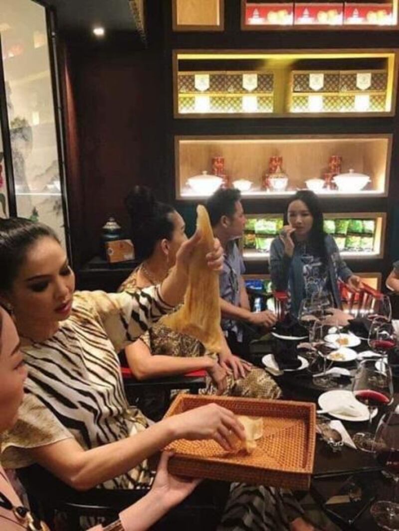 Cựu người mẫu Thủy Hương (bên trái, đang giơ tấm vây cá lên cao).