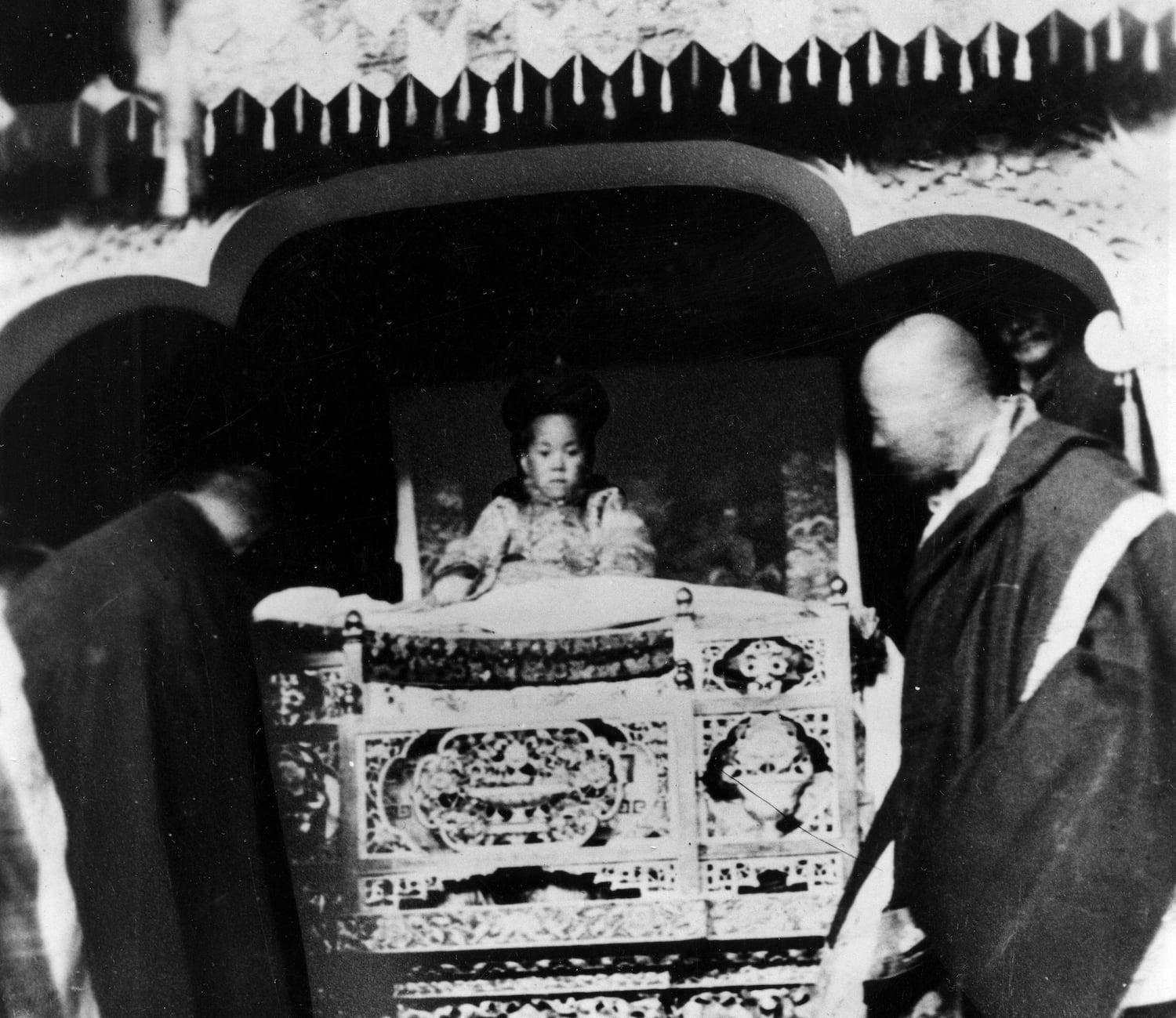 The 14th Dalai Lama, born Lhamo Thondup, is shown wearing royal robes in a golden palanquin at his enthronement in Lhasa, Tibet, Feb. 22, 1940.