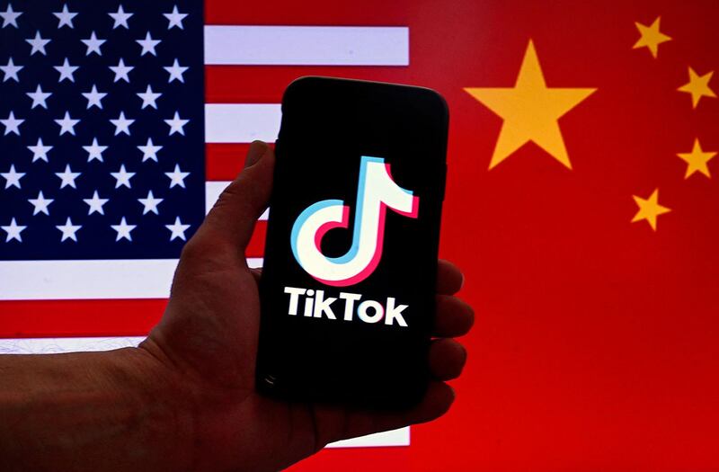 美国国会2022年底通过一项立法，其中禁止联邦政府设备使用TikTok。图为美中两国国旗与TikTok标志。（法新社图片）