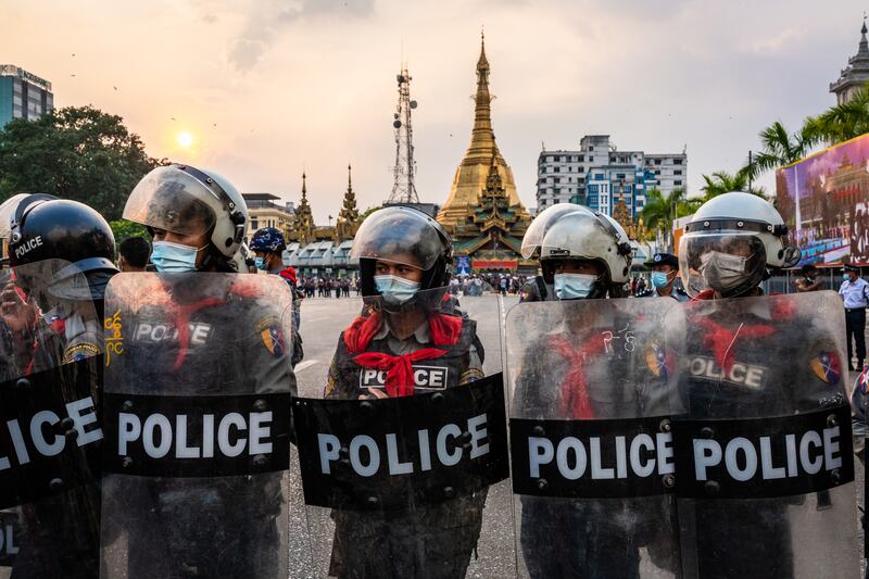 Riot police man a barrier in front of the Yangon City Hall on February 6, 2021 in Yangon, Myanmar.