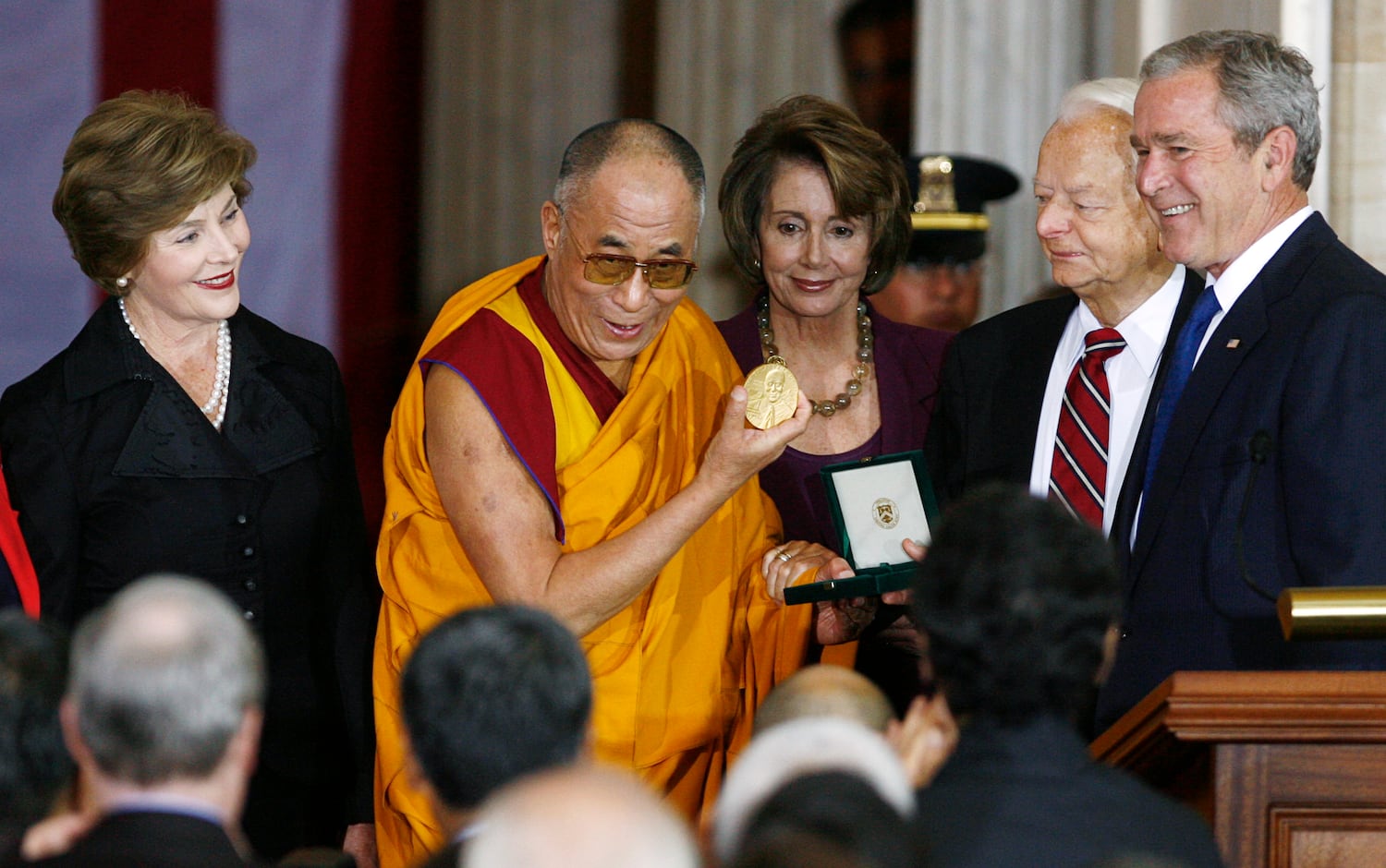 The Dalai Lama holds his U.S. Congressional Gold Medal as first lady Laura Bush, U.S. Speaker of the House Nancy Pelosi, D-Calif. U.S. Senate President Pro Tempore Robert Byrd, D-W.Va. and U.S. President George W. Bush at the U.S. Capitol, Oct. 17, 2007.