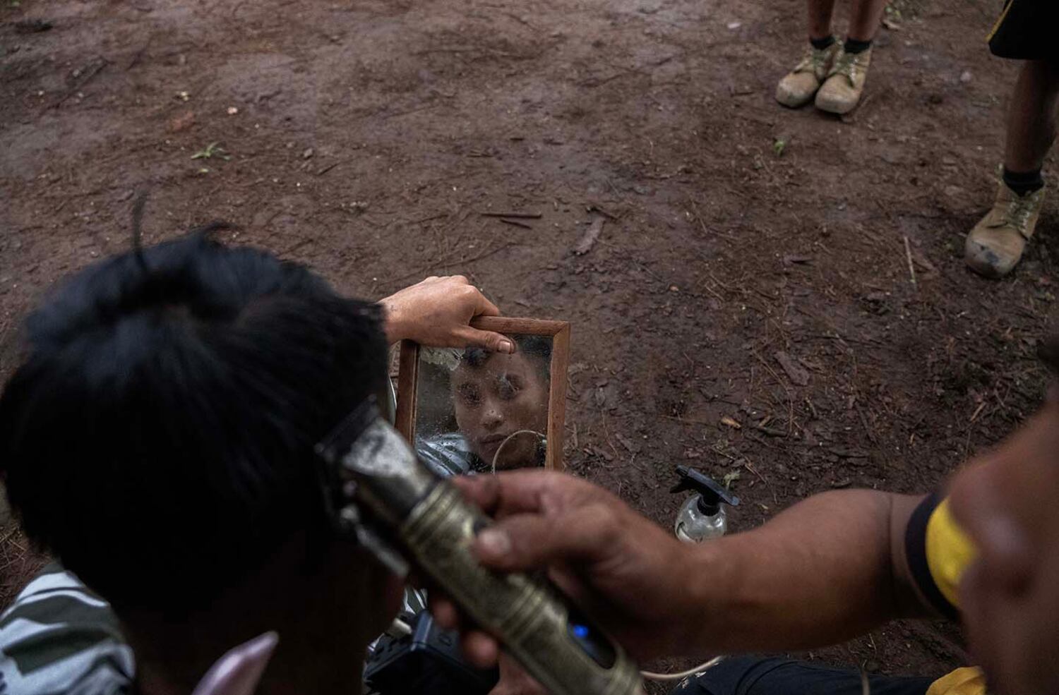 A fighter gets a haircut at a secret base where KNDF and PDF fighters and medics with the Free Burma Rangers train in southern Shan state, Myanmar, Oct. 29, 2024.