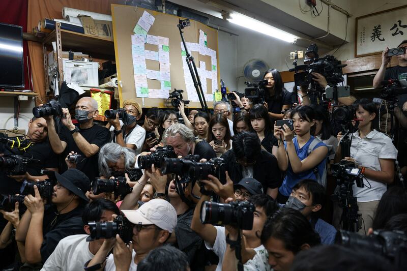 Reporters photograph the press conference where Chan Po-ying, Chair of Hong Kong’s League of Social Democrats, along with party members Jimmy Sham, Raphael Wong, and Figo Chan, announce the party’s dissolution in Hong Kong, June 29, 2025.