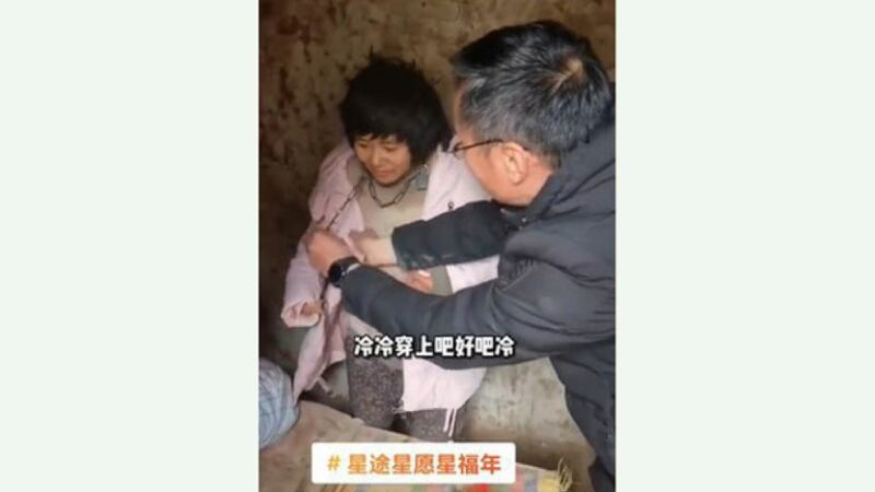 A woman, identified by authorities as Yang Qingxia, but known by her nickname Xiaohuamei, was found chained in a shed in China's Feng county in 2022. Credit: Screenshot from video