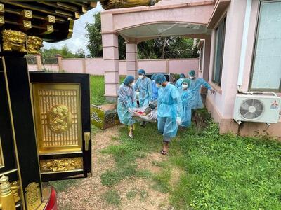Health workers wearing protective suits carry the body of suspected CVOVID-19 victim in Naypyidaw. Citizen journalist
