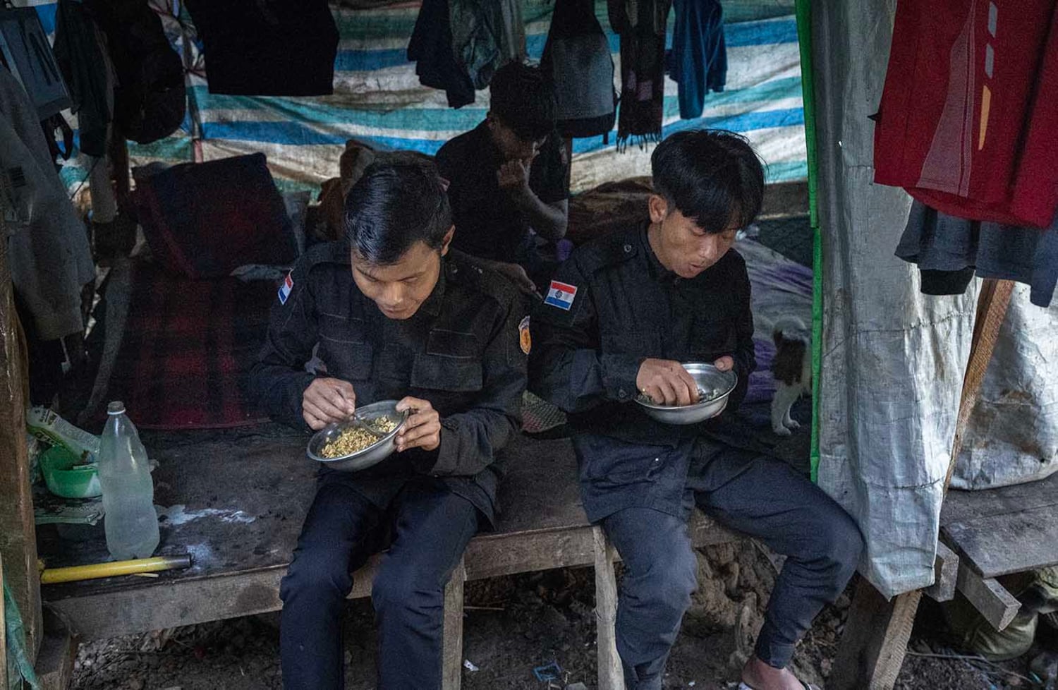 Officers at KSP Station 8 eat a meal provided by civilians in southern Shan state, Myanmar, Nov. 4, 2024.