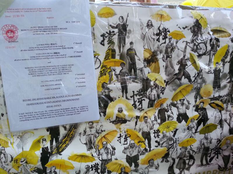 11月24日，禁制令列明，執達主任必要時可要求警方協助，警方有權逮捕懷疑阻礙執達主任執行禁制令的人士，並盡快帶上法庭。（粵語部林靜攝）