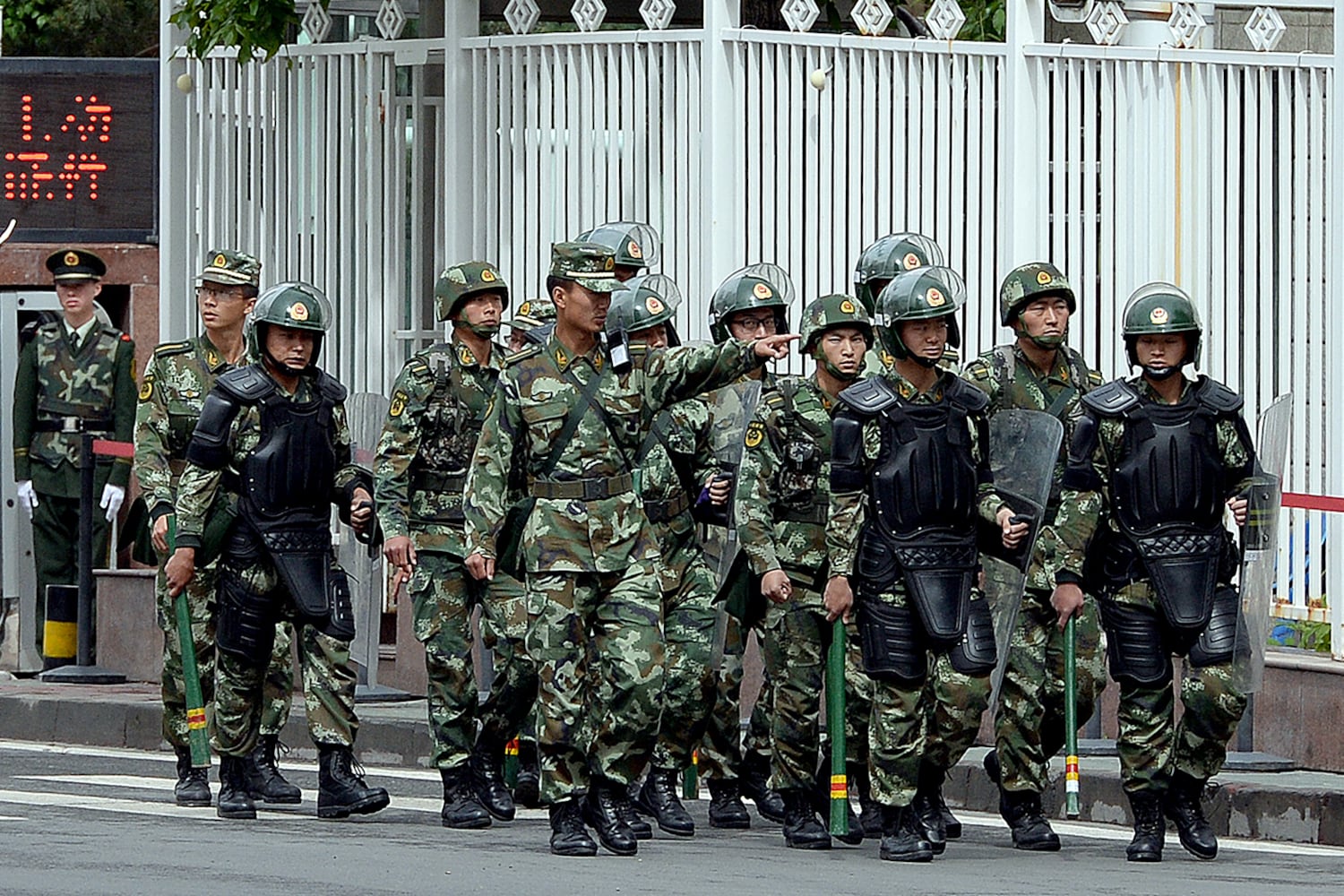 Armed Chinese paramilitary police patrol a street in Urumqi, capital of northwestern China's Xinjiang region, May 23, 2014.